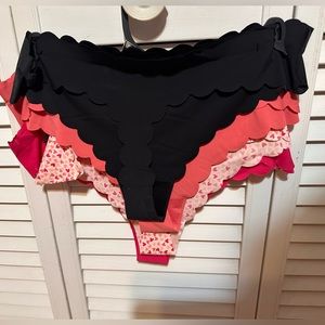 New, still on hangers with tags, four pack XL seamless thong panties